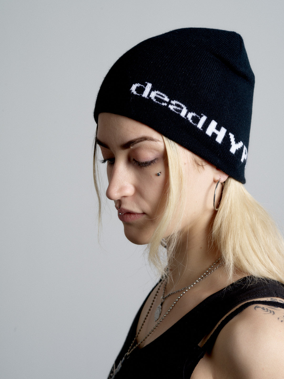 Person wearing a black beanie with 'deadHYPE' text on a plain background